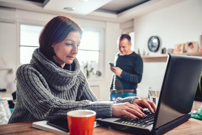 Woman using laptop at home office