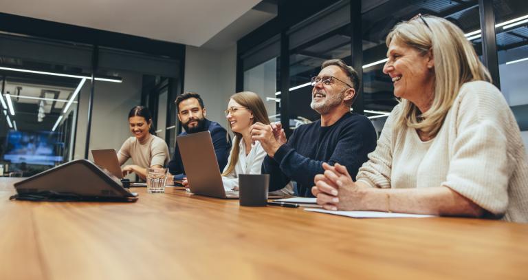 Cheerful business professionals laughing during a briefing