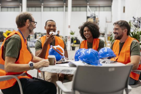 Multiracial engineers team having a coffee break in factory